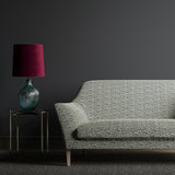 Sofa upholstered in a monochrome wavy geometric weave fabric.
