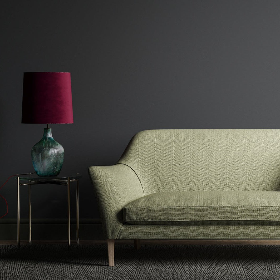 Sofa upholstered in a black and neutral geometric fabric.