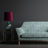 Sofa upholstered in a dark blue fabric with a small white print