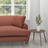 Sofa upholstered in a brick red plain washable furnishing fabric