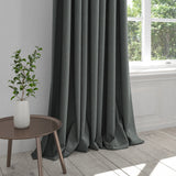 Curtain upholstered in a dark indigo blue plain cotton fabric