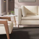 Living room with a contemporary sofa upholstered in a light pink semi-plain Scandi-style upholstery fabric
