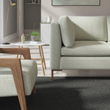 Living room with a contemporary sofa upholstered in a dark grey semi-plain Scandi-style upholstery fabric