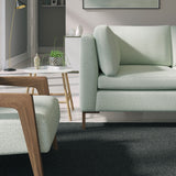 Living room with a contemporary sofa upholstered in a light blue semi-plain Scandi-style upholstery fabric