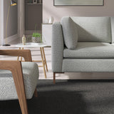 Living room with a contemporary sofa upholstered in a dark blue semi-plain Scandi-style upholstery fabric