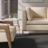 Living room with a contemporary sofa upholstered in a dark orange semi-plain Scandi-style upholstery fabric