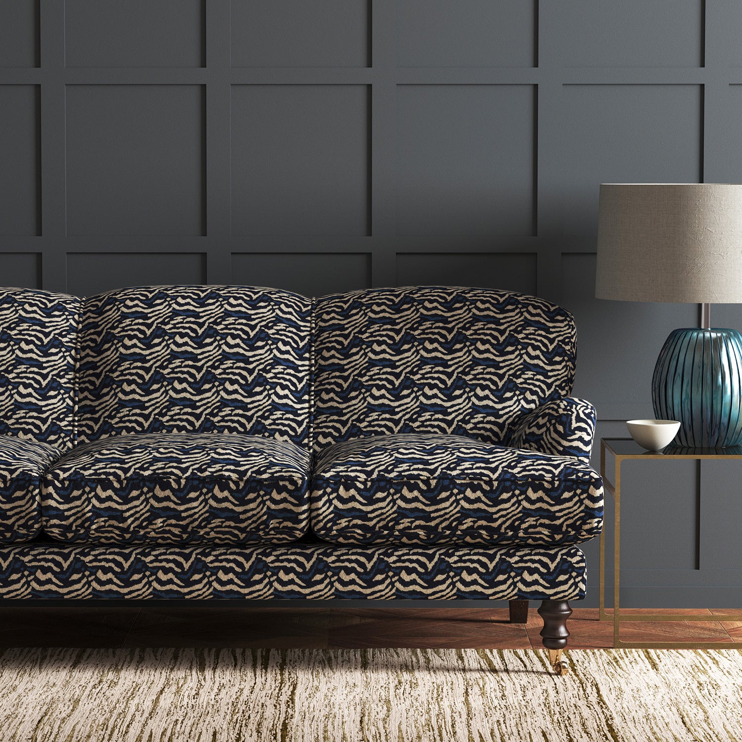 Velvet sofa in a dark blue velvet fabric with abstract animal print design