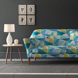 Velvet sofa upholstered in a velvet stain resistant fabric with a blue geometric design