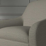 Close up of a chair covered in a woven fabric in a herringbone design in Zinc
