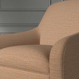 Close up of a chair covered in a woven fabric in a herringbone design in Burnt Orange