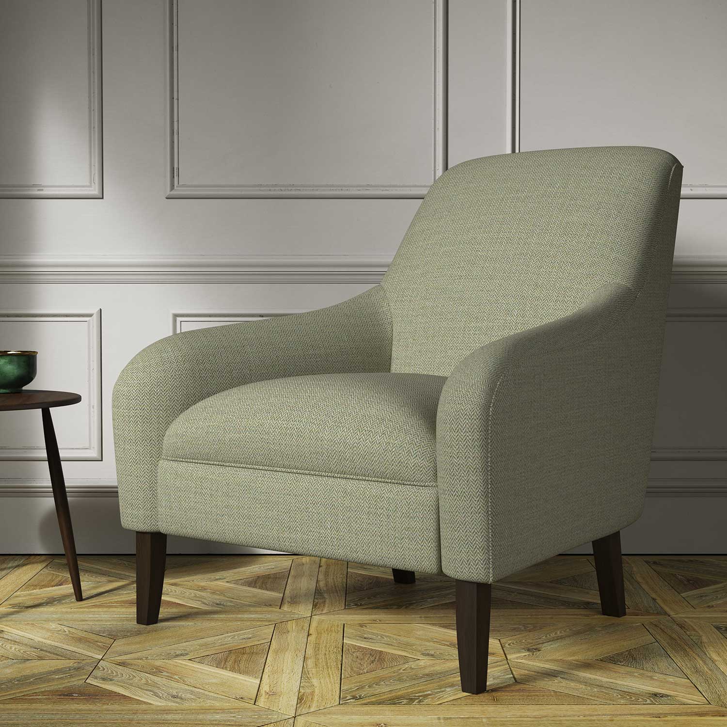 Chair covered in a woven fabric in a herringbone design in Fern