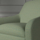 Close up of a chair covered in a woven fabric in a herringbone design in Seagrass