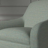 Close up of a chair covered in a woven fabric in a herringbone design in Kingfisher