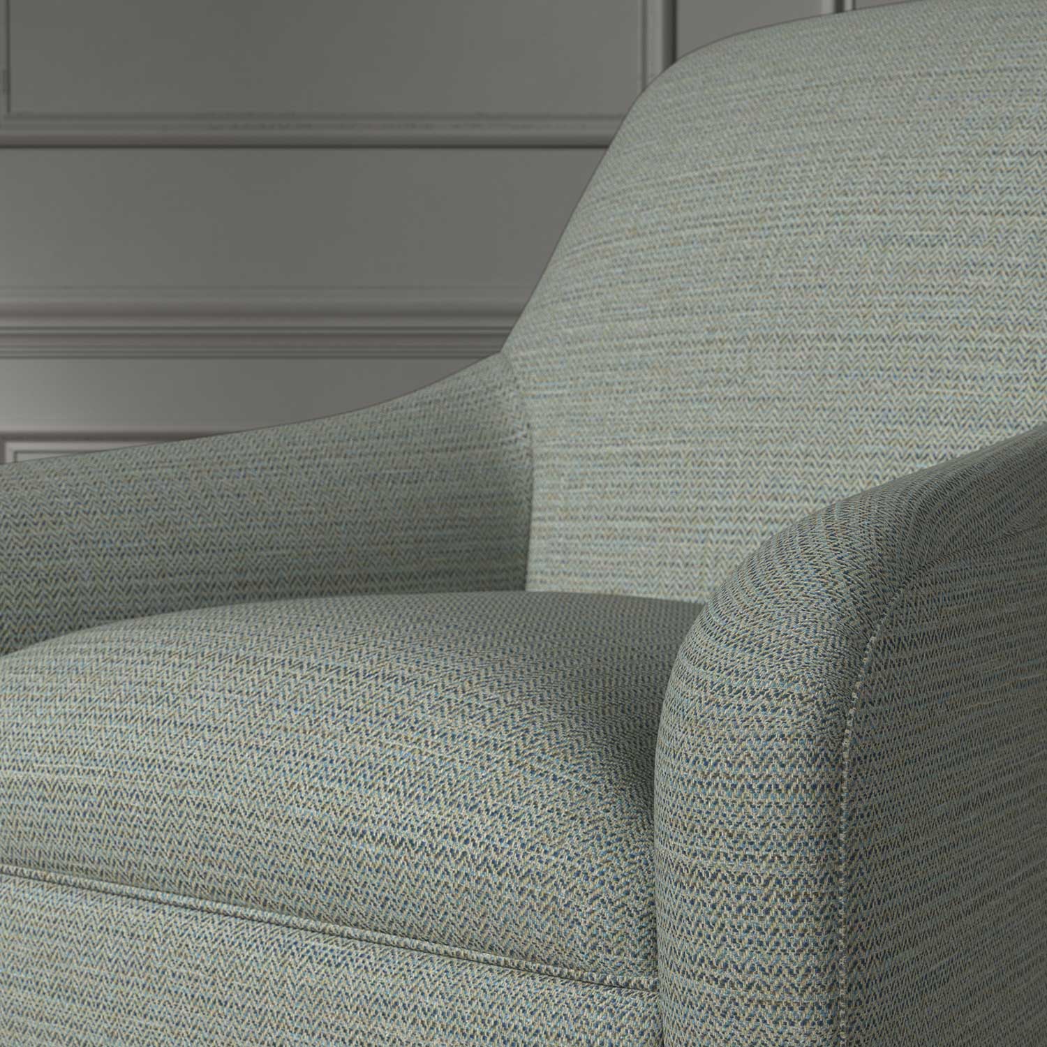 Close up of a chair covered in a woven fabric in a herringbone design in Denim