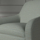 Close up of a chair covered in a woven fabric in a herringbone design in Denim