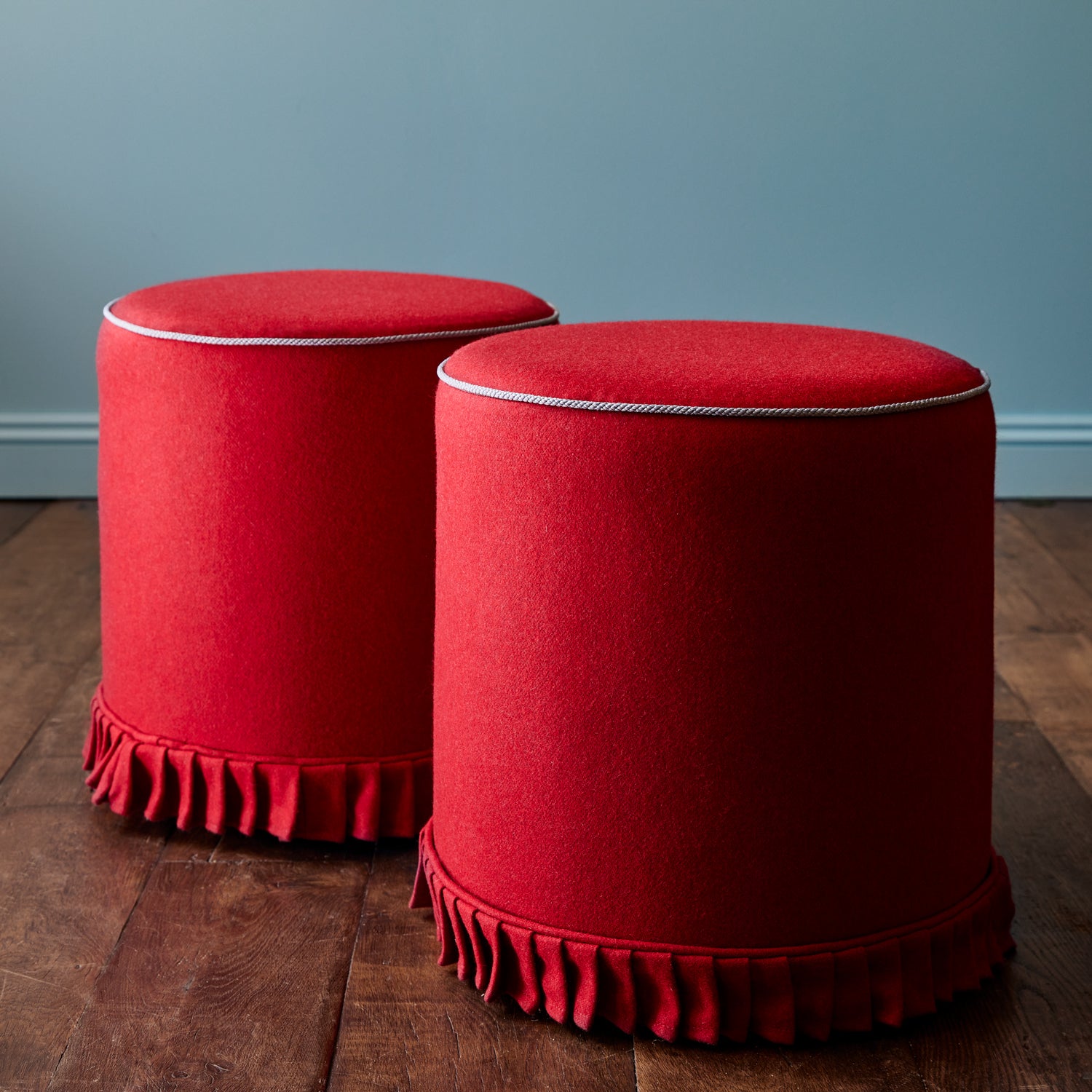 A red woven fabric shown on stools.