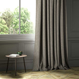 A grey woven fabric on an armchair.