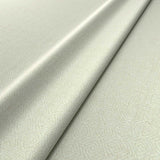 Fabric swatch of a cream woven fabric for upholstery