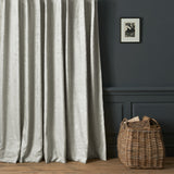 Curtains in a contemporary damask fabric in a light neutral colour.