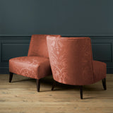 Armchairs in a contemporary damask fabric in a terracotta colour.
