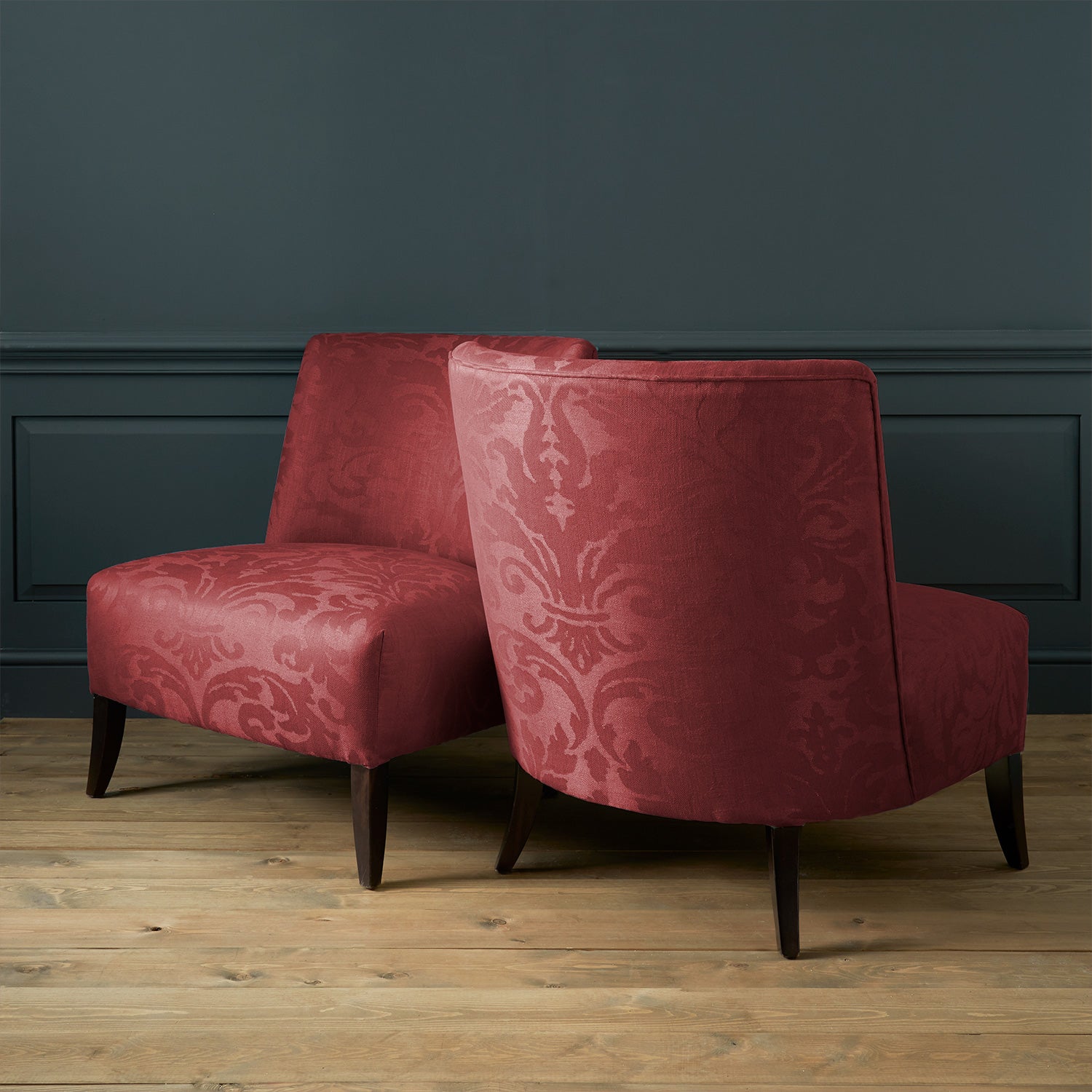 Armchairs in a contemporary damask fabric in a burgundy colour.