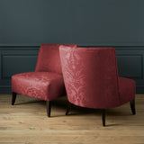 Armchairs in a contemporary damask fabric in a burgundy colour.