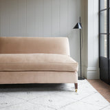 Pink velvet upholstery fabric on a classic sofa.
