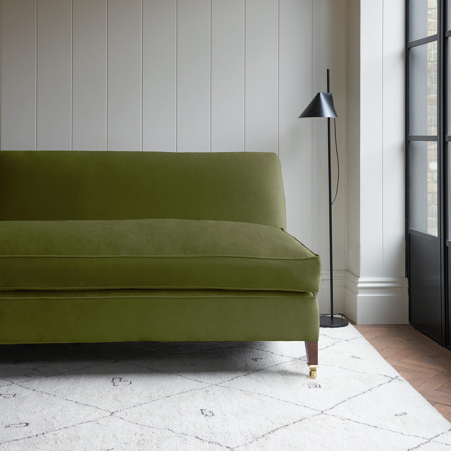 Green velvet upholstery fabric on a classic sofa.