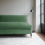 Green velvet upholstery fabric on a classic sofa.