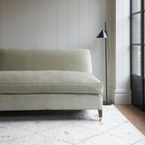 Neutral velvet upholstery fabric on a classic sofa.
