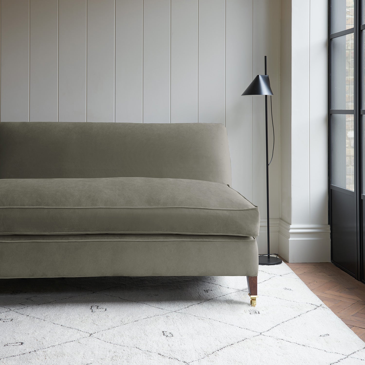 Neutral velvet upholstery fabric on a classic sofa.