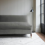 Grey velvet upholstery fabric on a classic sofa.