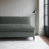 Grey velvet upholstery fabric on a classic sofa.