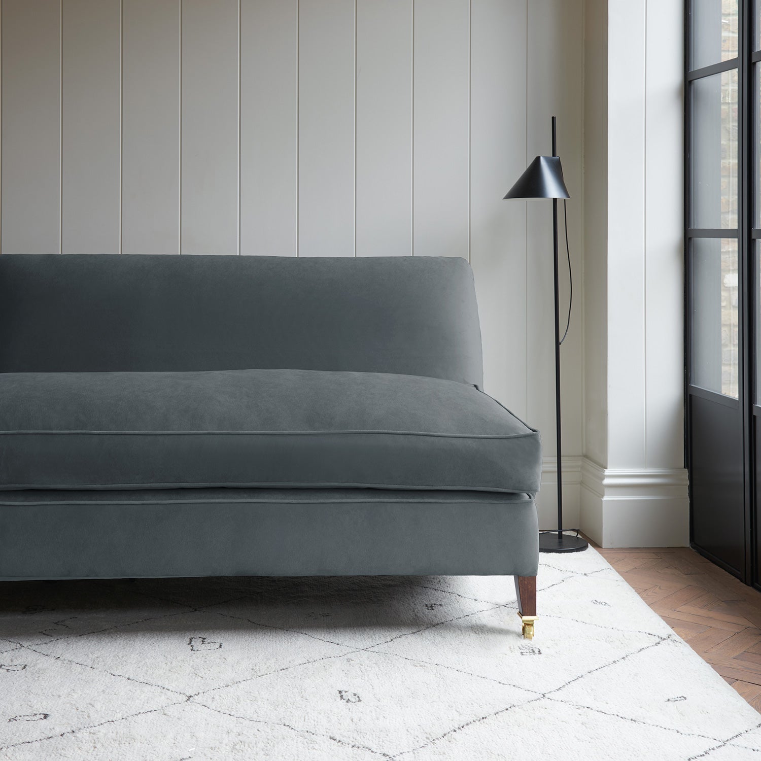 Grey velvet upholstery fabric on a classic sofa.