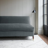 Grey velvet upholstery fabric on a classic sofa.