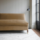 Brown velvet upholstery fabric on a classic sofa.