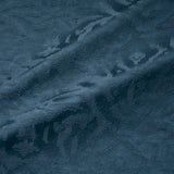 Fabric swatch of a dark blue, soft fabric with jacquard design for curtain use