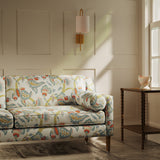 Sofa upholstered in a linen fabric with a floral vine design
