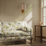 Sofa upholstered in a linen fabric with a floral vine design