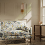 Sofa upholstered in a linen fabric with a floral vine design