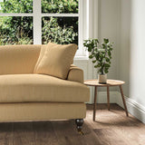 A yellow stain resistant woven fabric on an armchair.