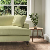 A green stain resistant woven fabric on an armchair.