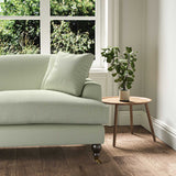 A green, stain resistant woven fabric on an armchair.