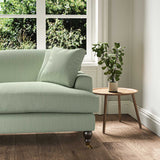 A green stain resistant woven fabric on an armchair.