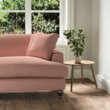 A pink stain resistant woven fabric on an armchair.