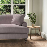 A purple stain resistant woven fabric on an armchair.