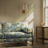 Sofa upholstered in a linen fabric with a floral and bird design