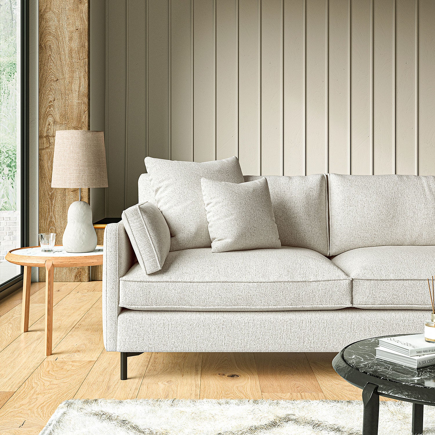 Sofa covered in a boucle fabric in Linen