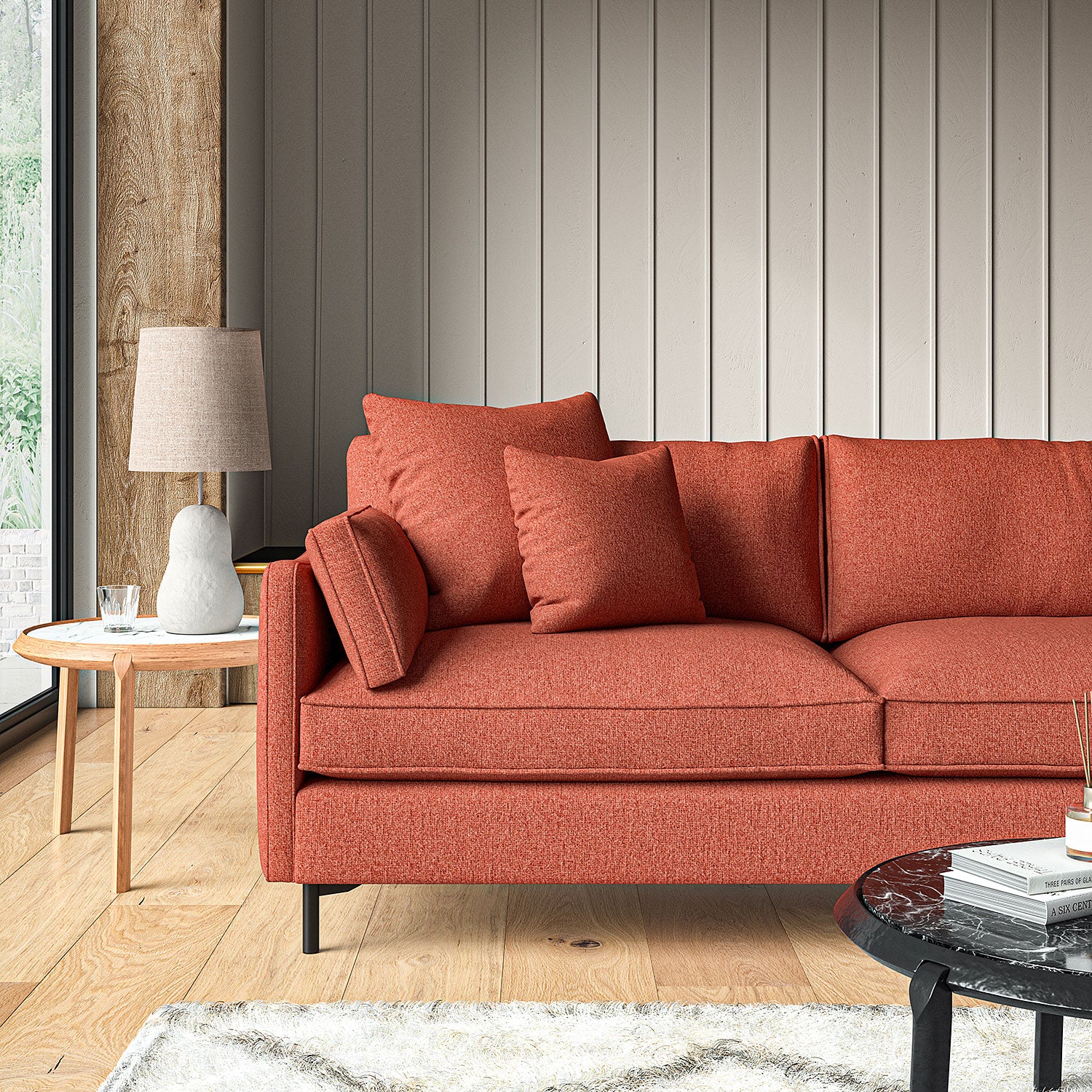 Sofa covered in a boucle fabric in Carnelian