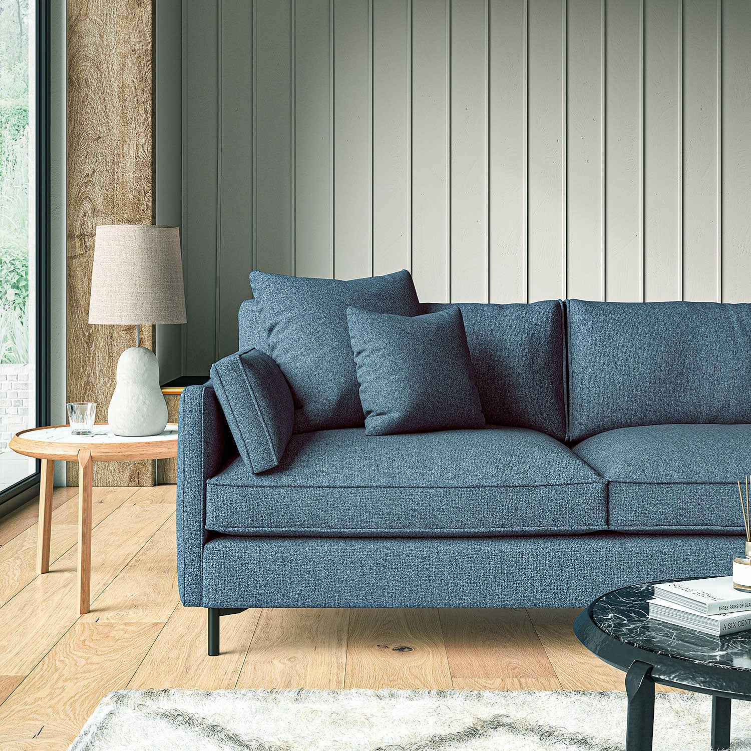 Sofa covered in a boucle fabric in Sapphire